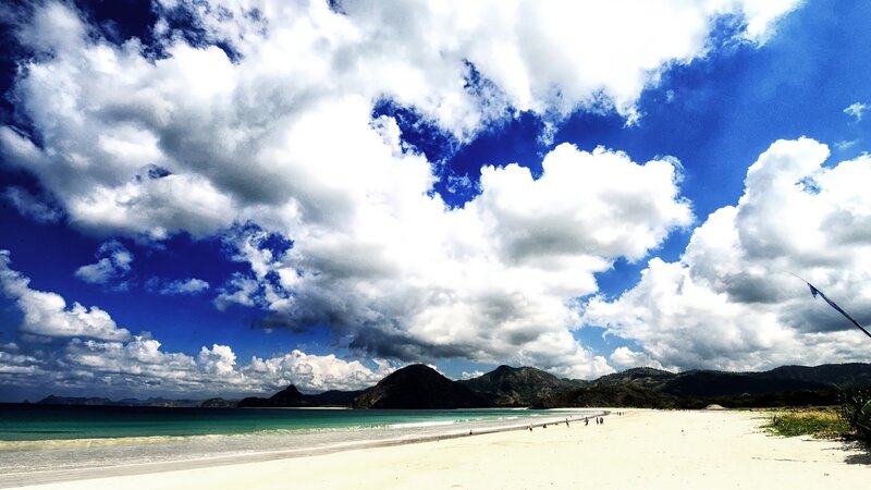 beach with mountains and clouds