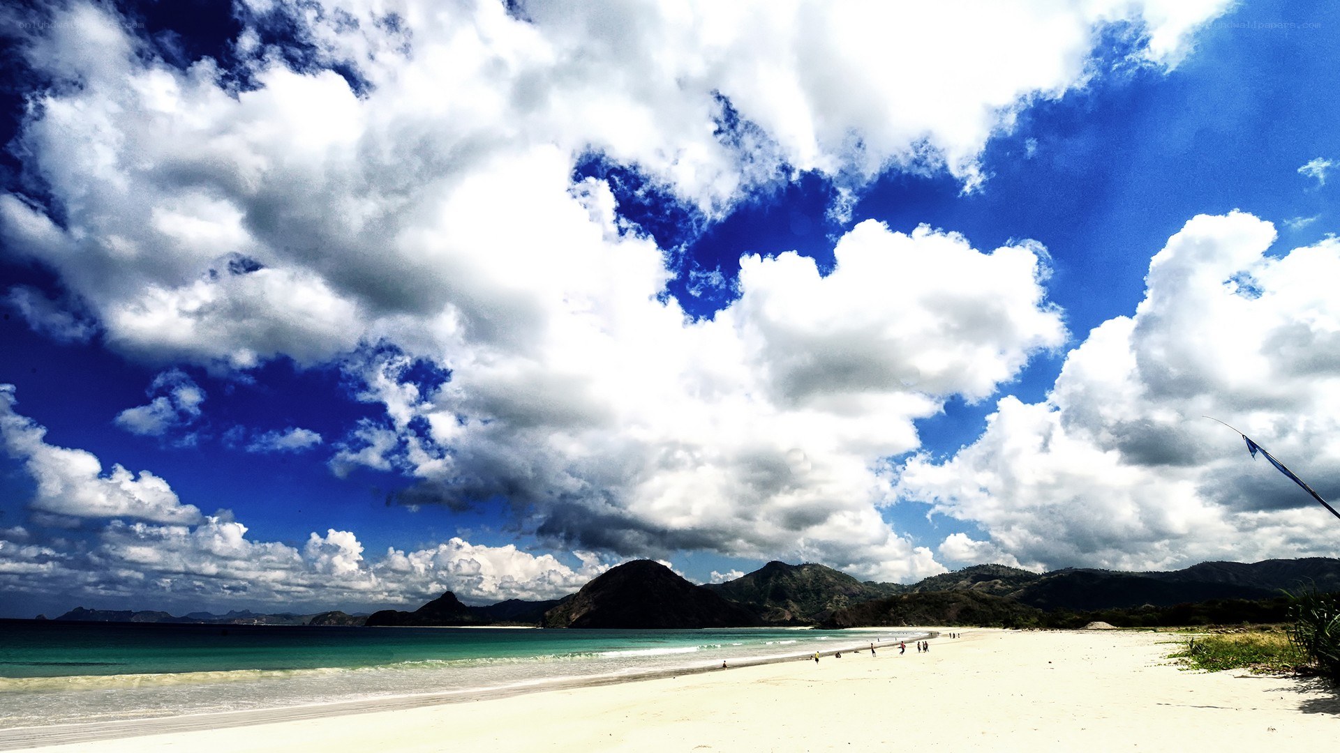 beach with mountains and clouds