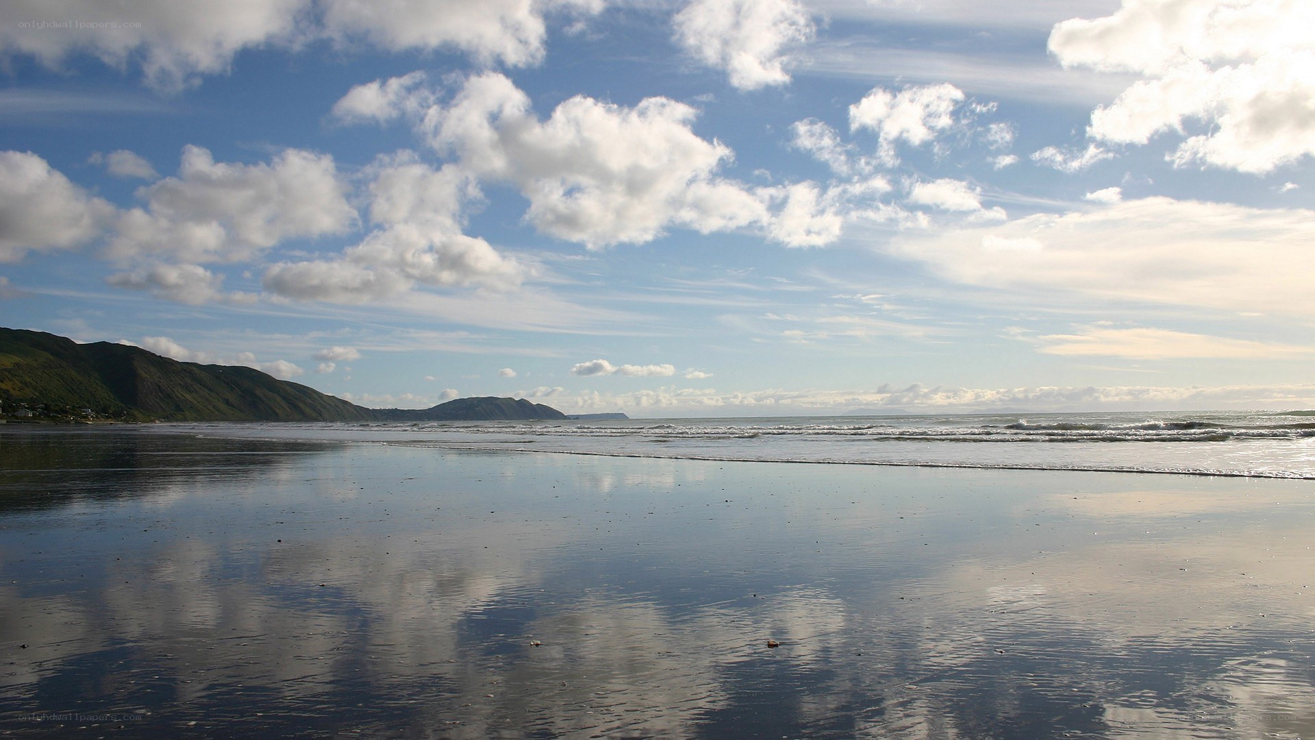 Beach with mountains and clouds