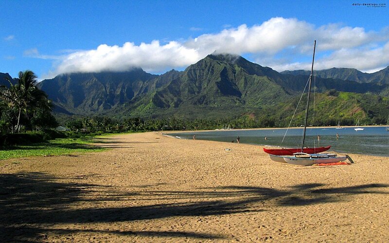 beach with mountains and sailboats