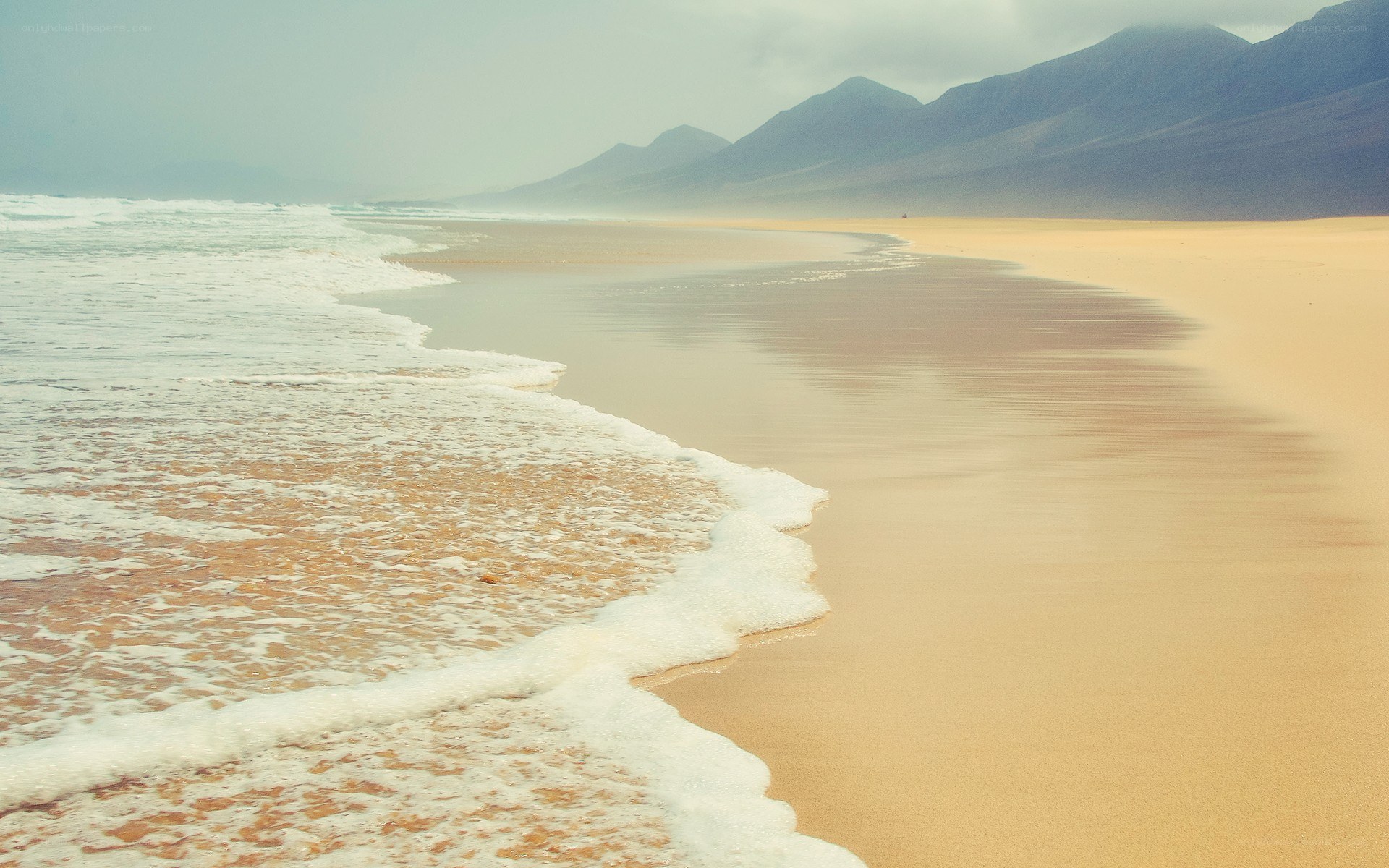 beach with mountains in background