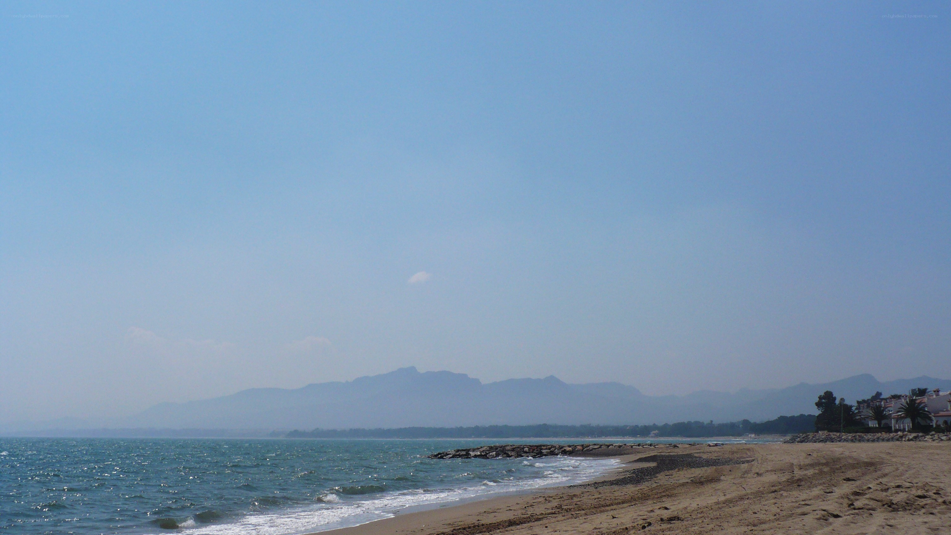 beach with mountains in background