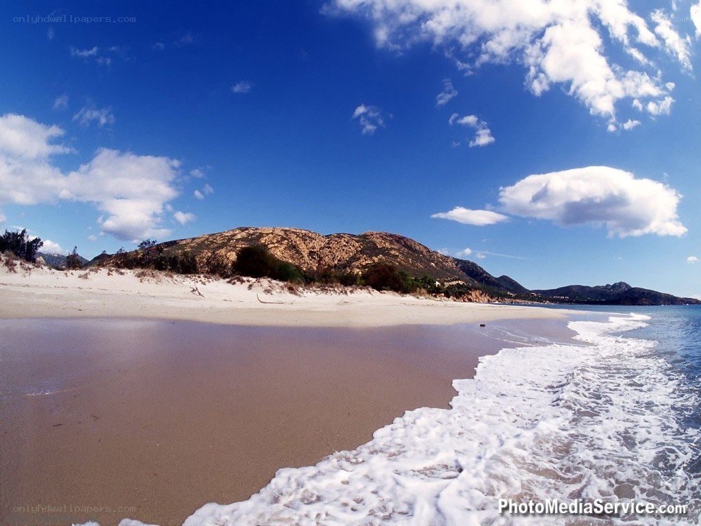 beach with mountains in background