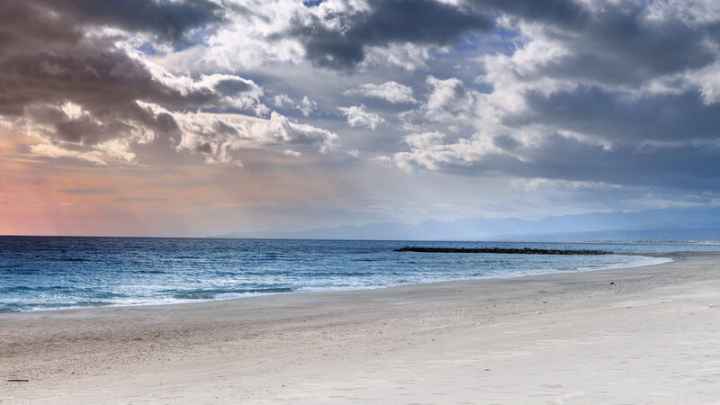 Beach with Ocean Waves — Blue, Dramatic, Sunset, Photograph, Clouds, Mountains, Breakwater