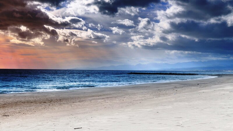 Beach with Ocean Waves — Blue, Dramatic, Sunset, Photograph, Clouds, Mountains, Sand