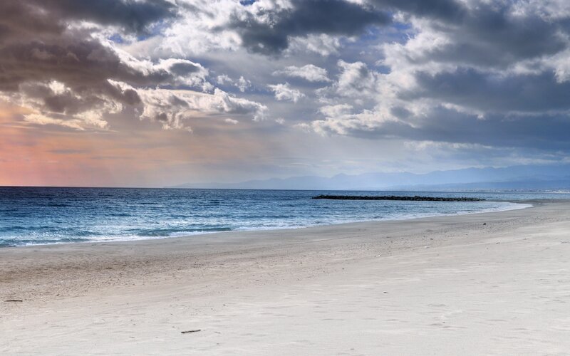 Beach with Ocean Waves — Blue, Dramatic, Sunset, Photograph, Clouds, Mountains