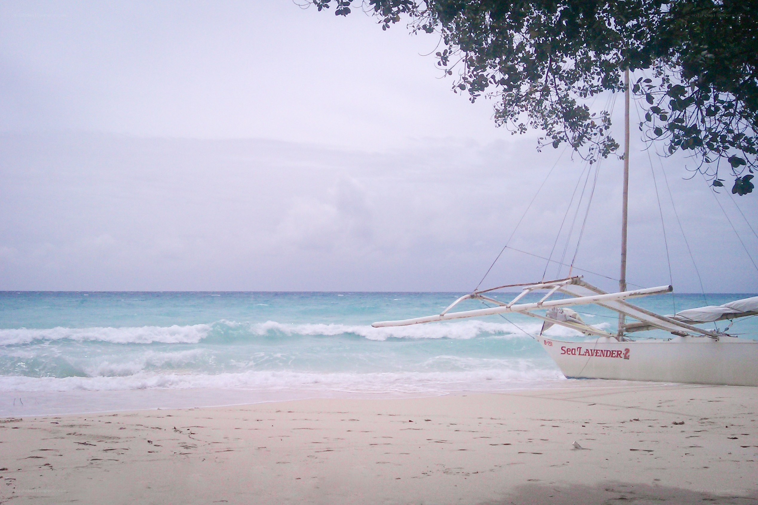 Beach with outrigger boat