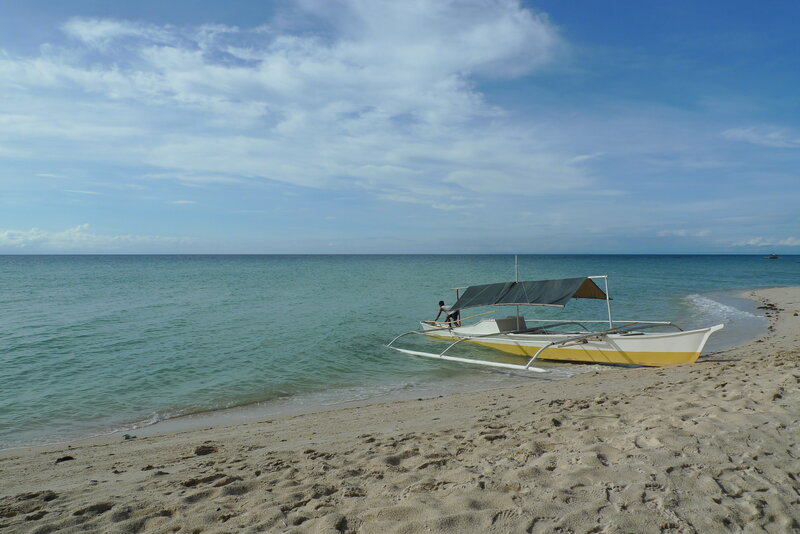 Beach with outrigger boat