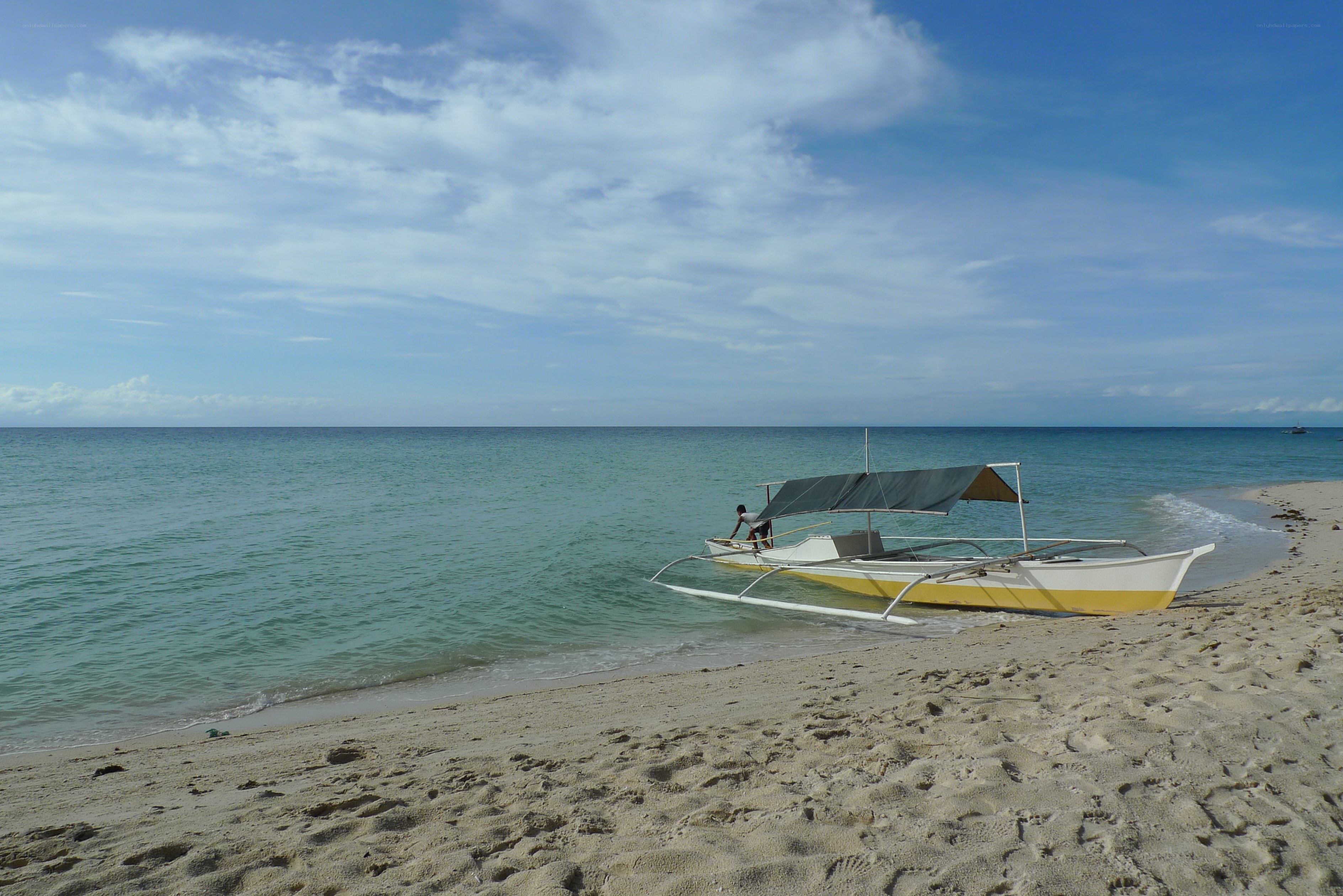 Beach with outrigger boat