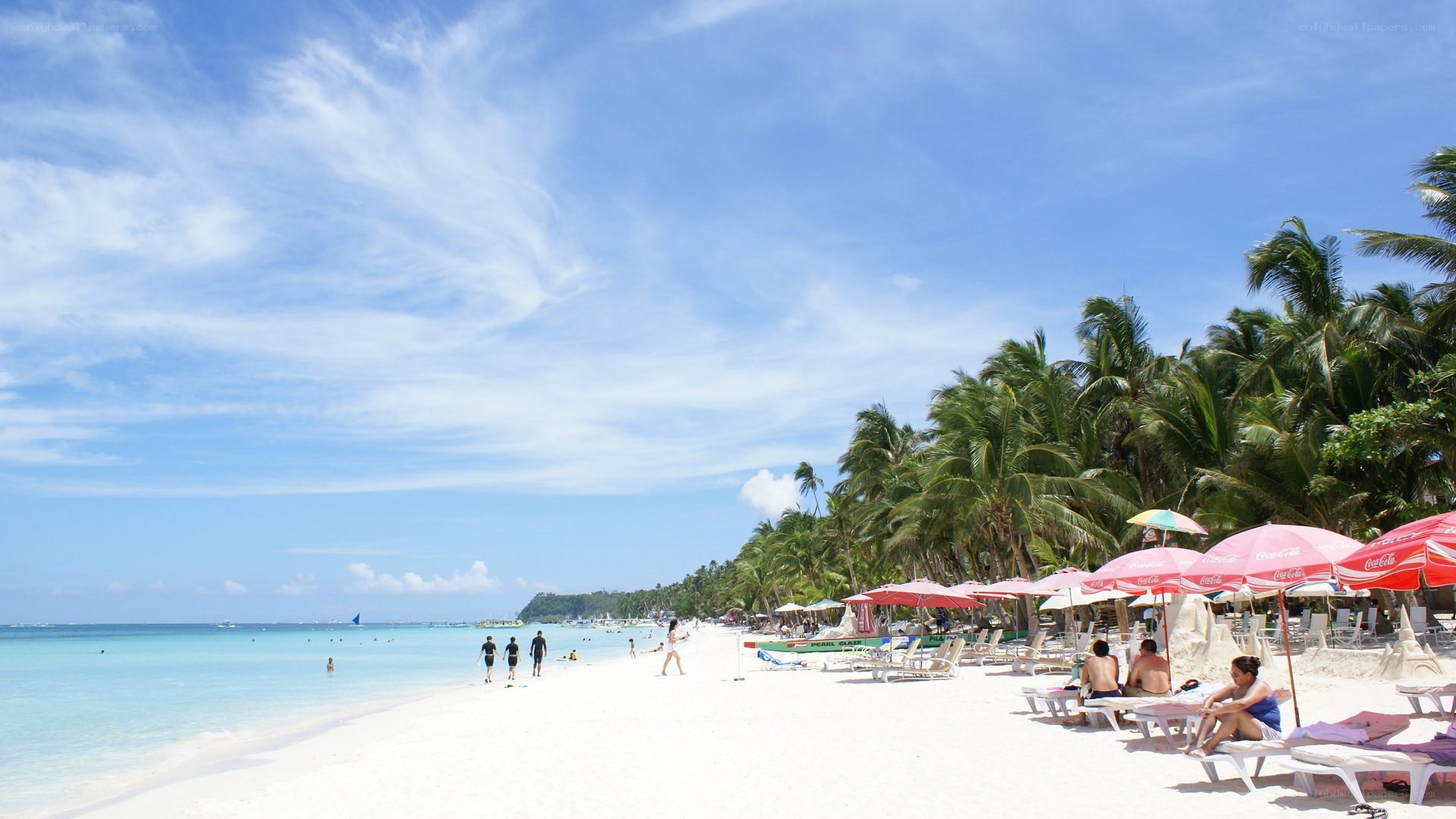 Beach with palm trees and umbrellas