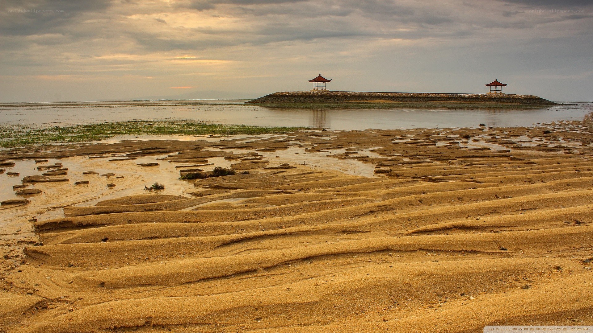 Beach with pavilions at low tide