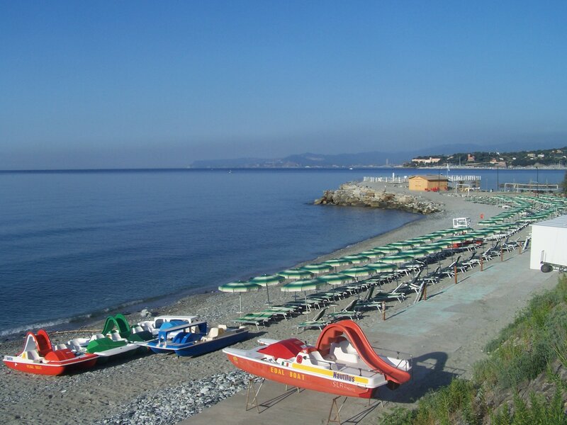 Beach with pedal boats and umbrellas