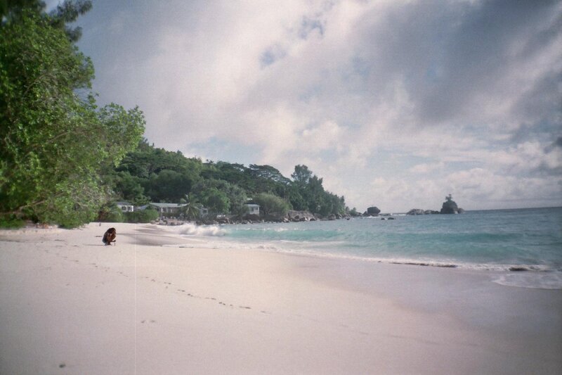 beach with person and houses