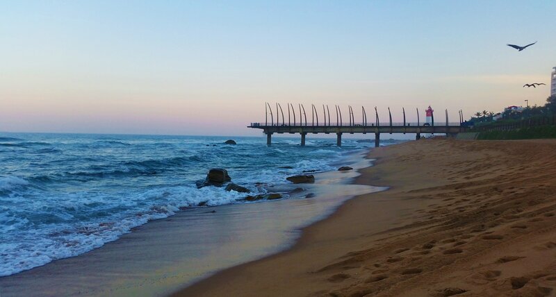 Beach with Pier and Lighthouse