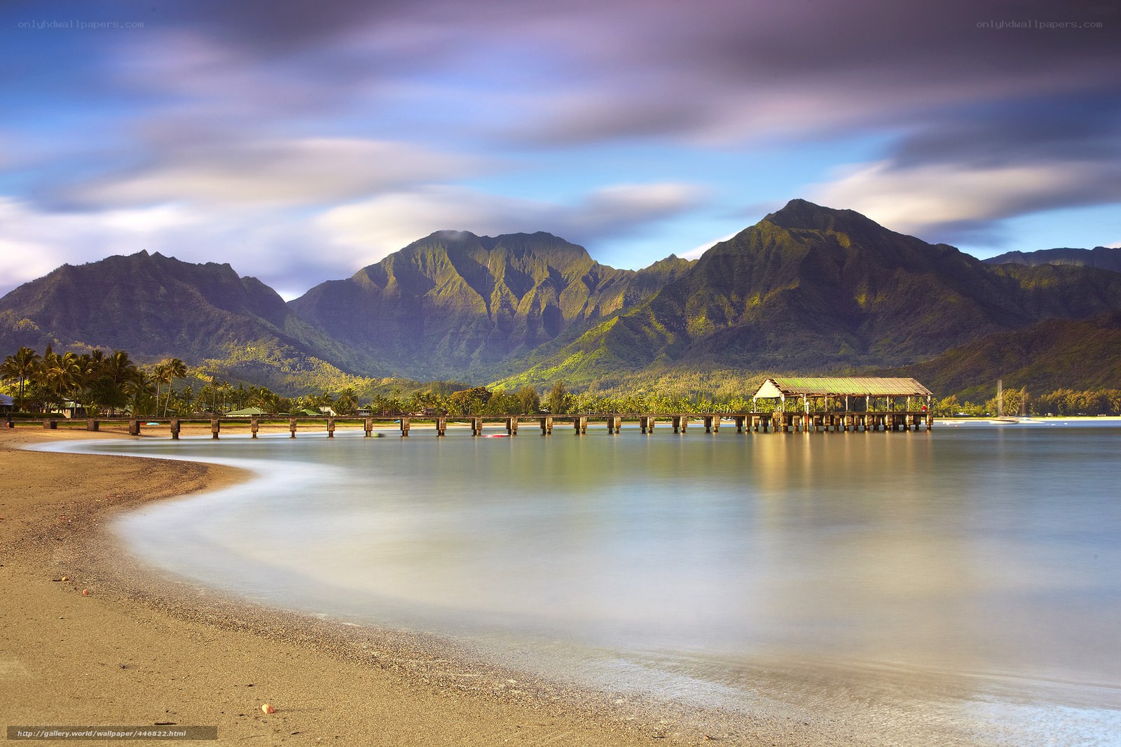 Beach with pier and mountains