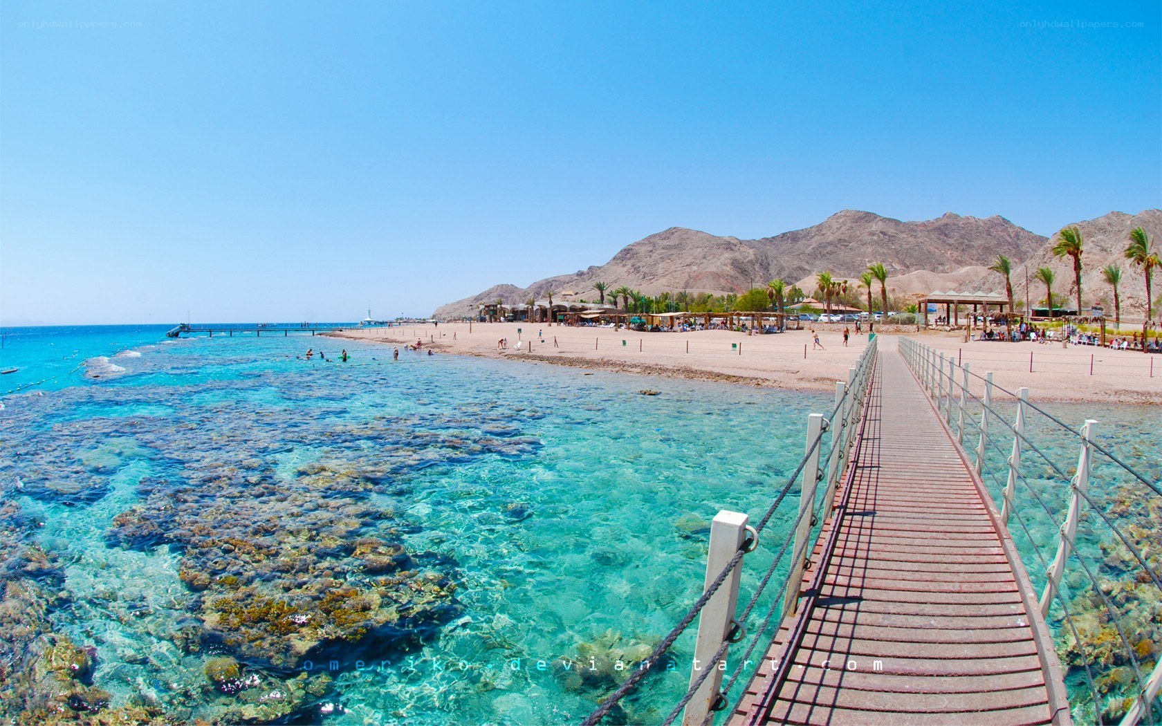 Beach with pier and mountains
