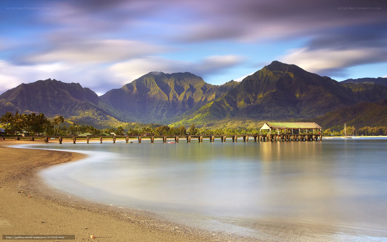 Beach with pier and mountains