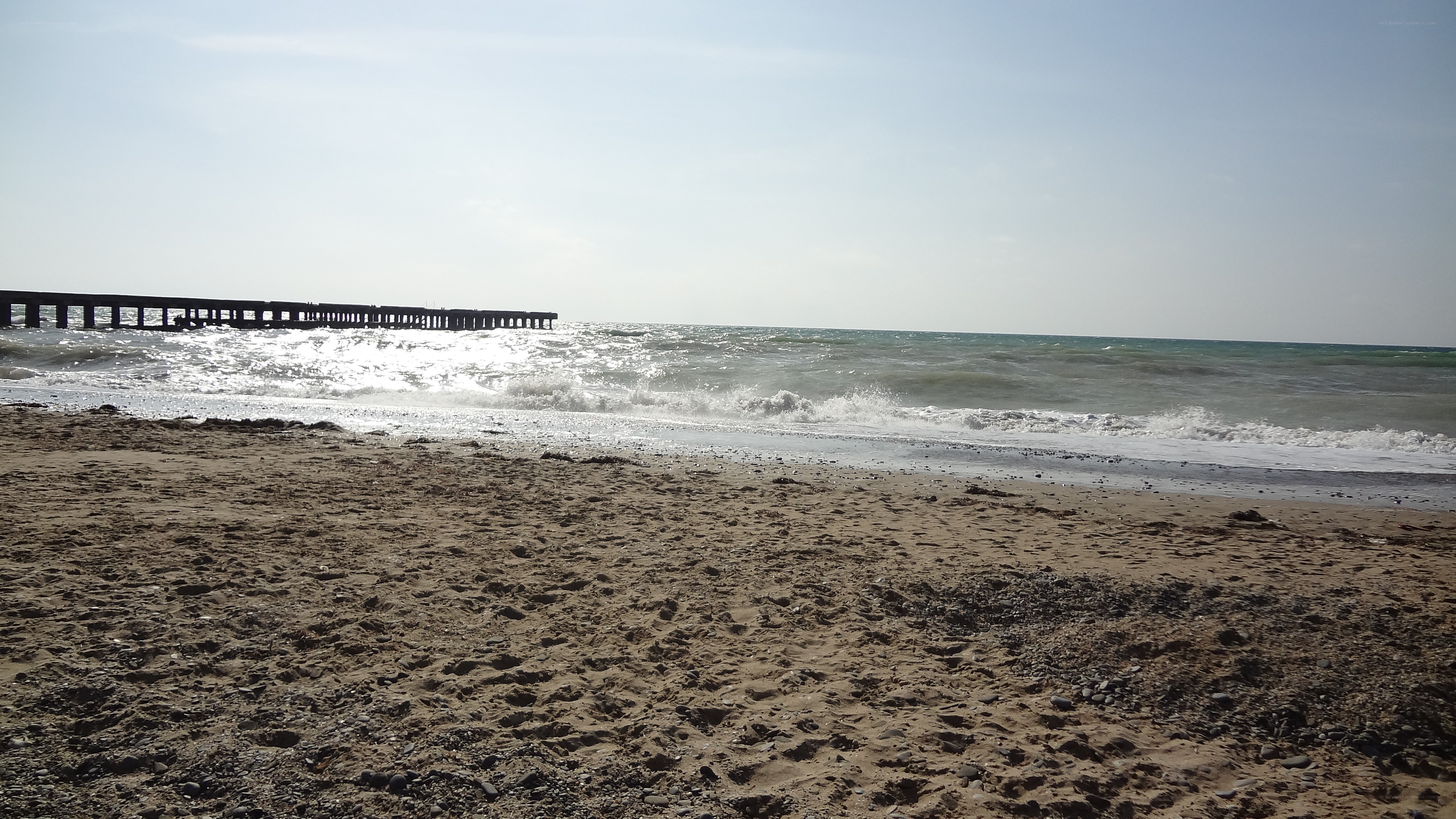 beach with pier and waves