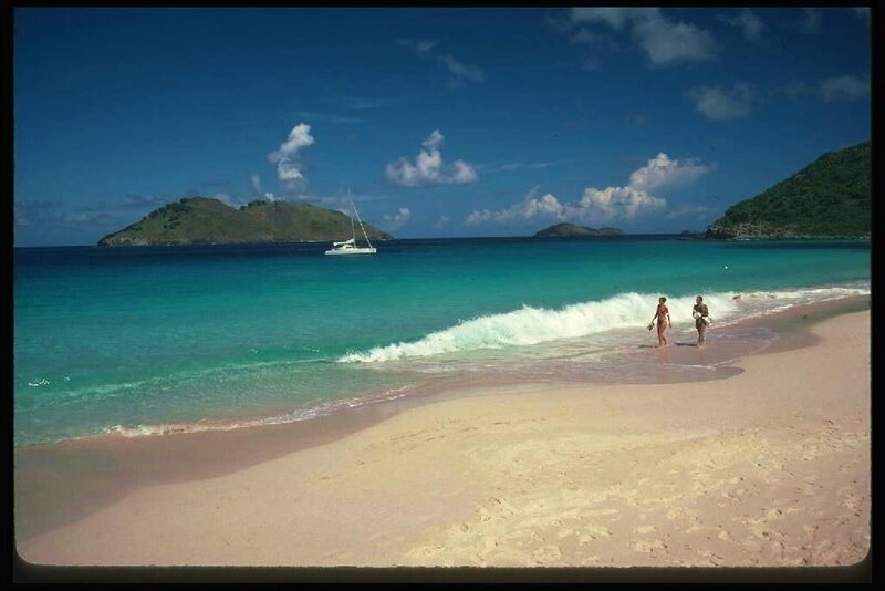 Beach with pink sand and sailboat