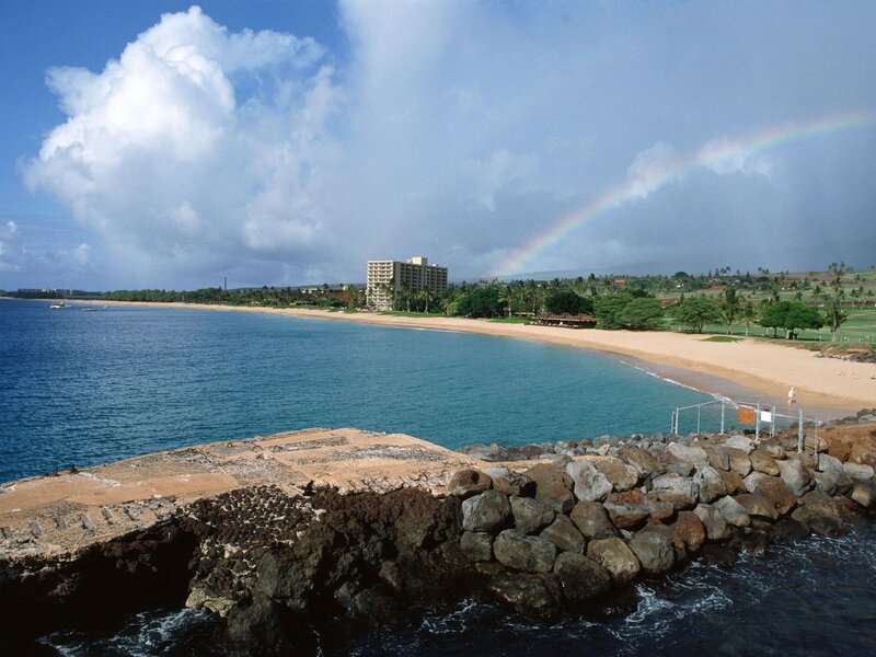 beach with rainbow and hotel