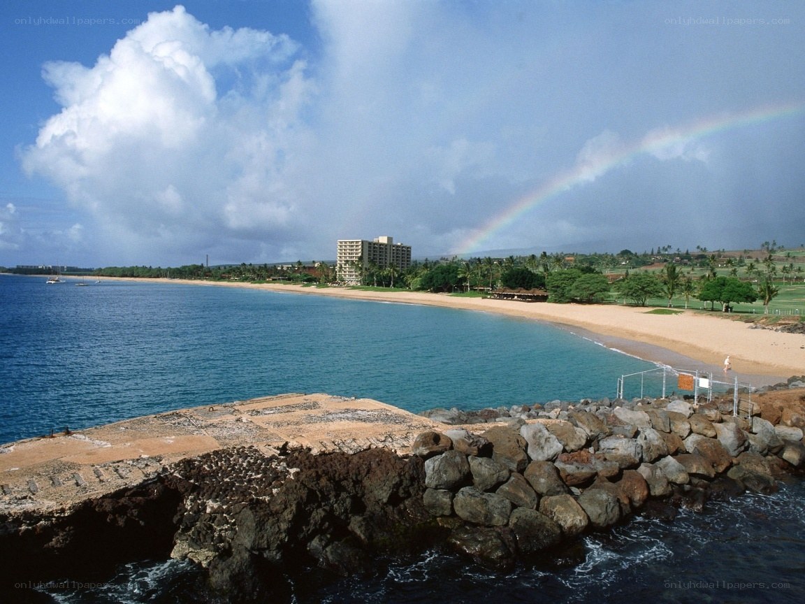 beach with rainbow and hotel