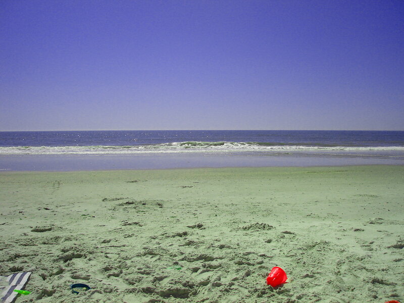 Beach with red bucket