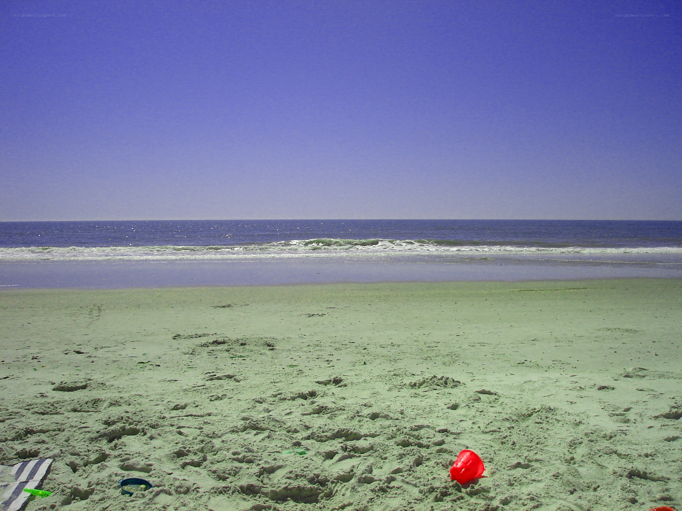 Beach with red bucket