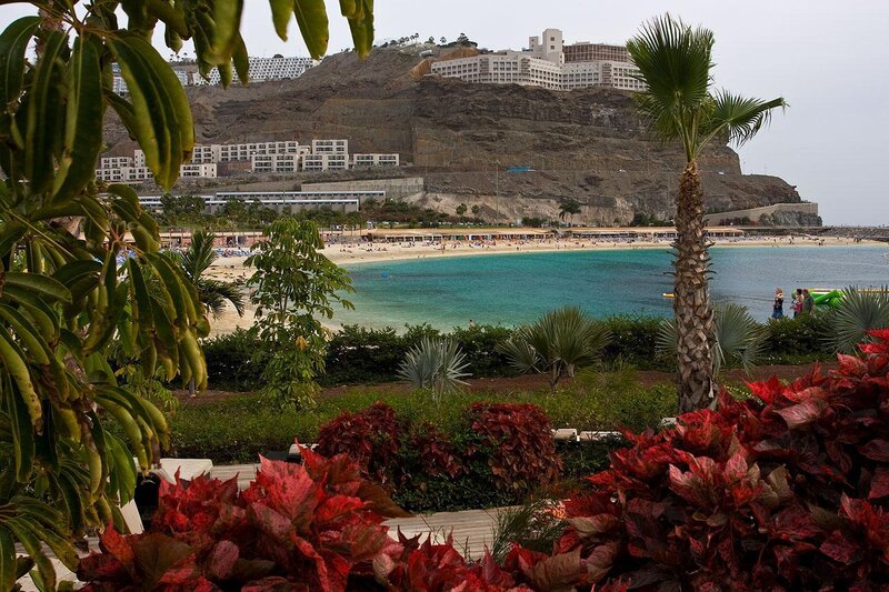 Beach with resort on hillside