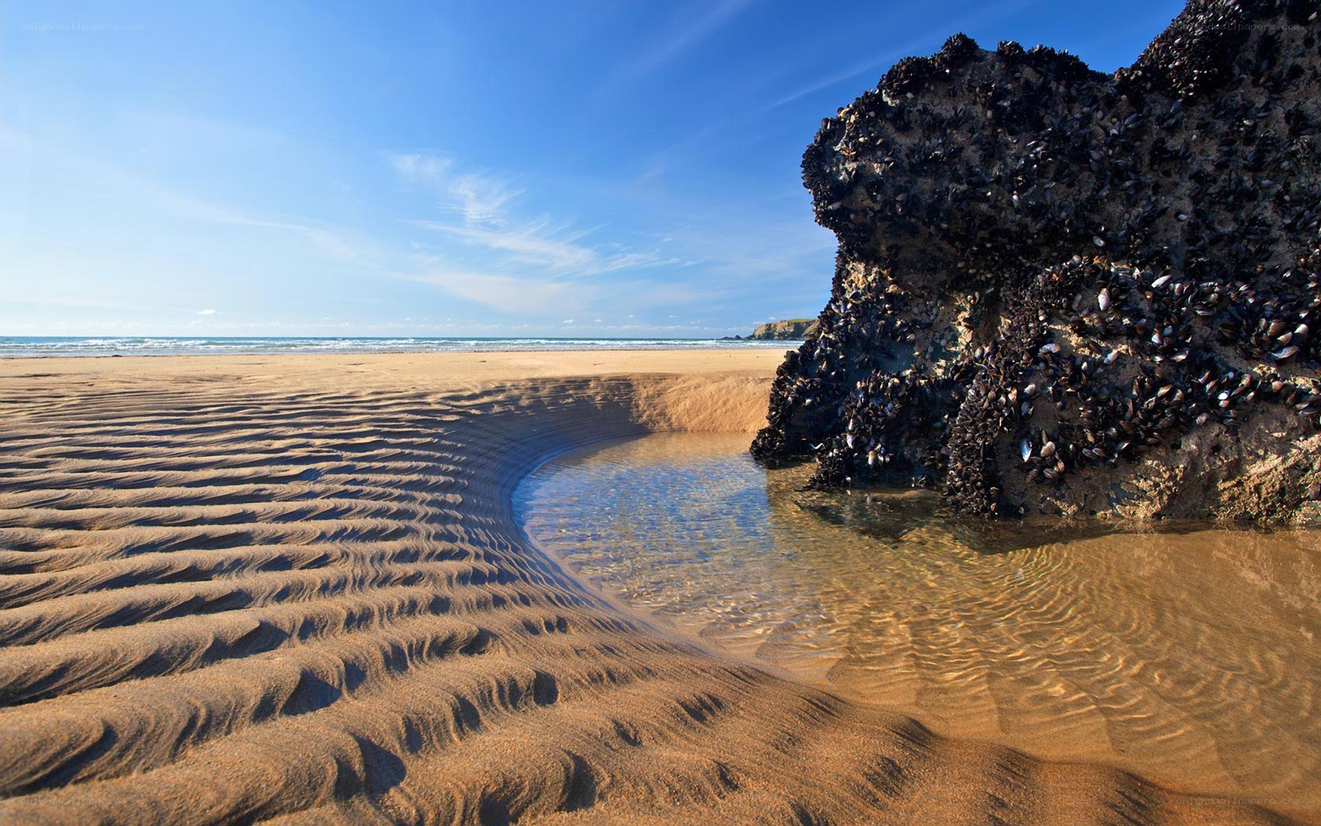 beach with rippled sand and rock