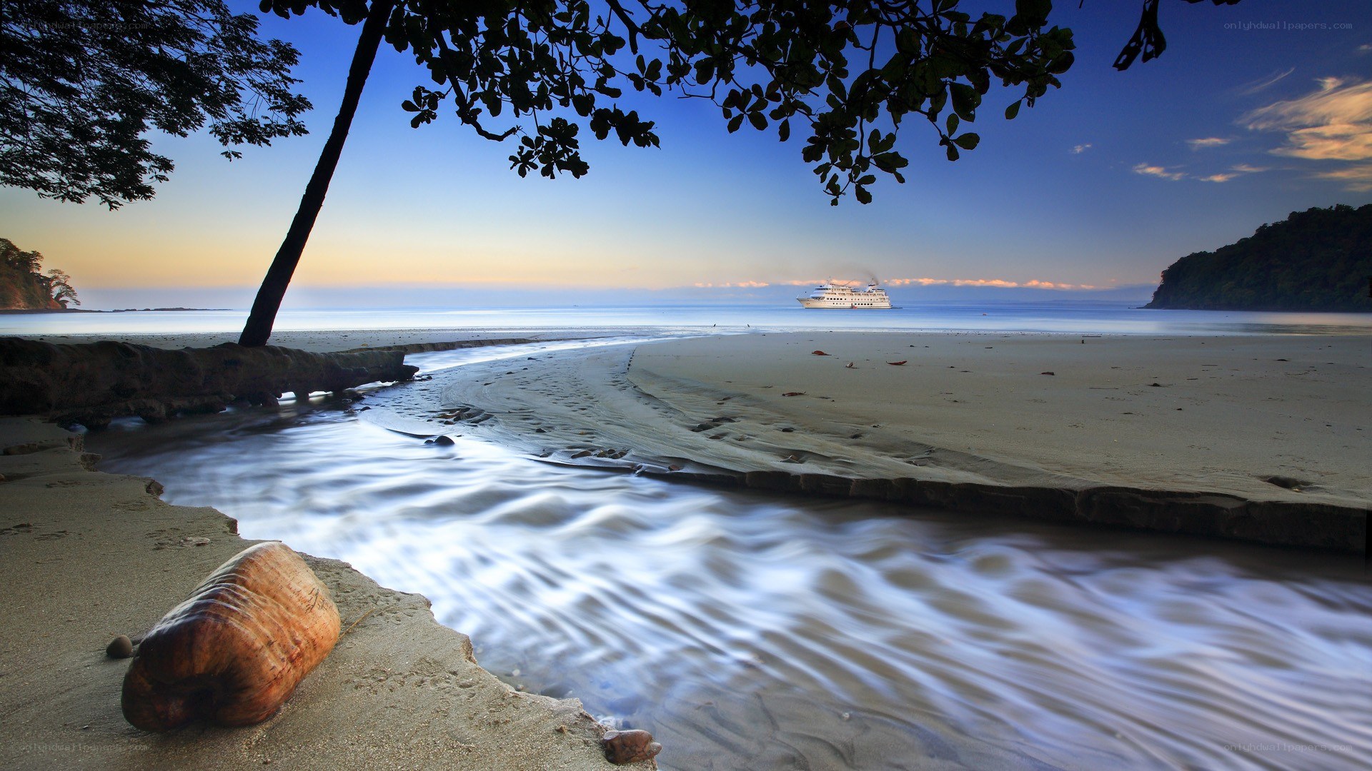beach with river and cruise ship