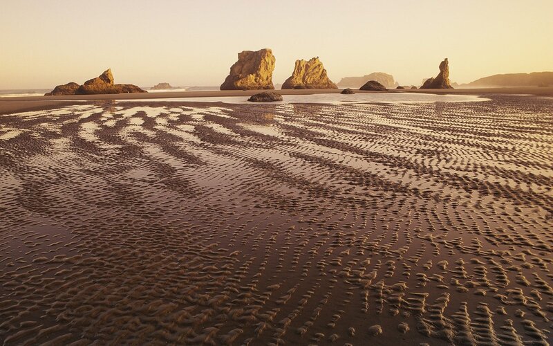beach with rock formations at sunset
