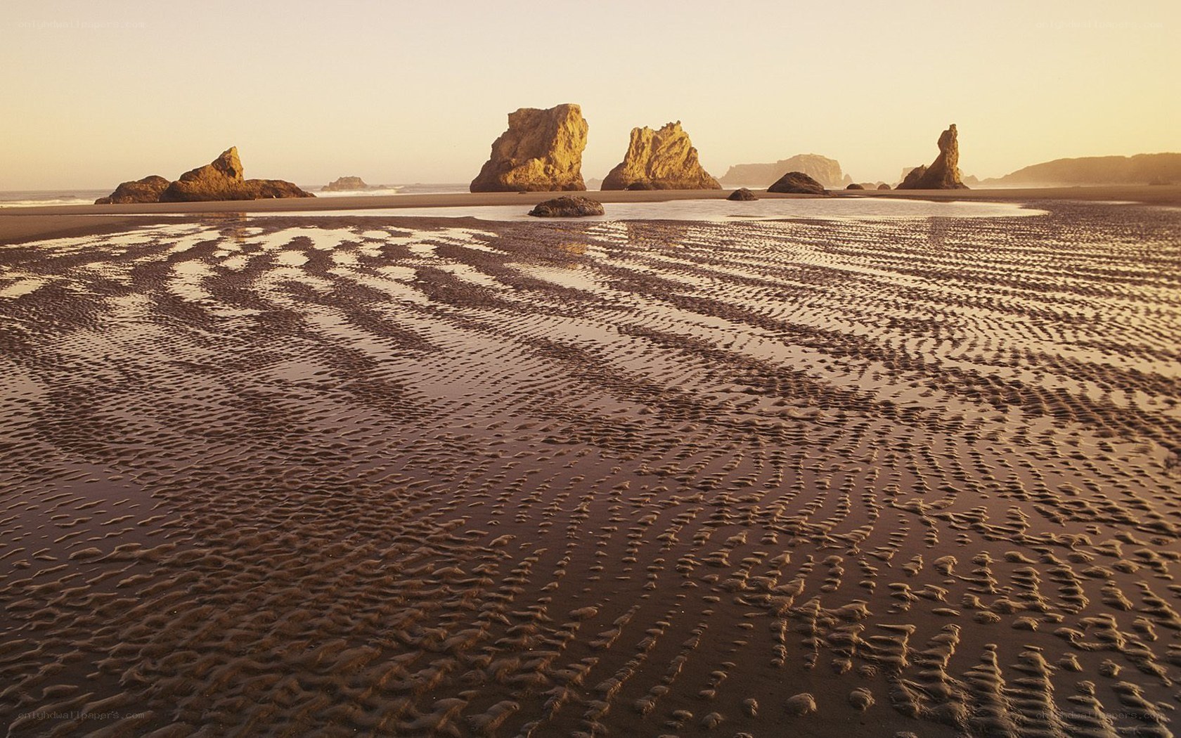 beach with rock formations at sunset