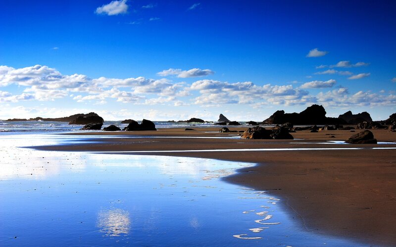Beach with rocks and blue sky