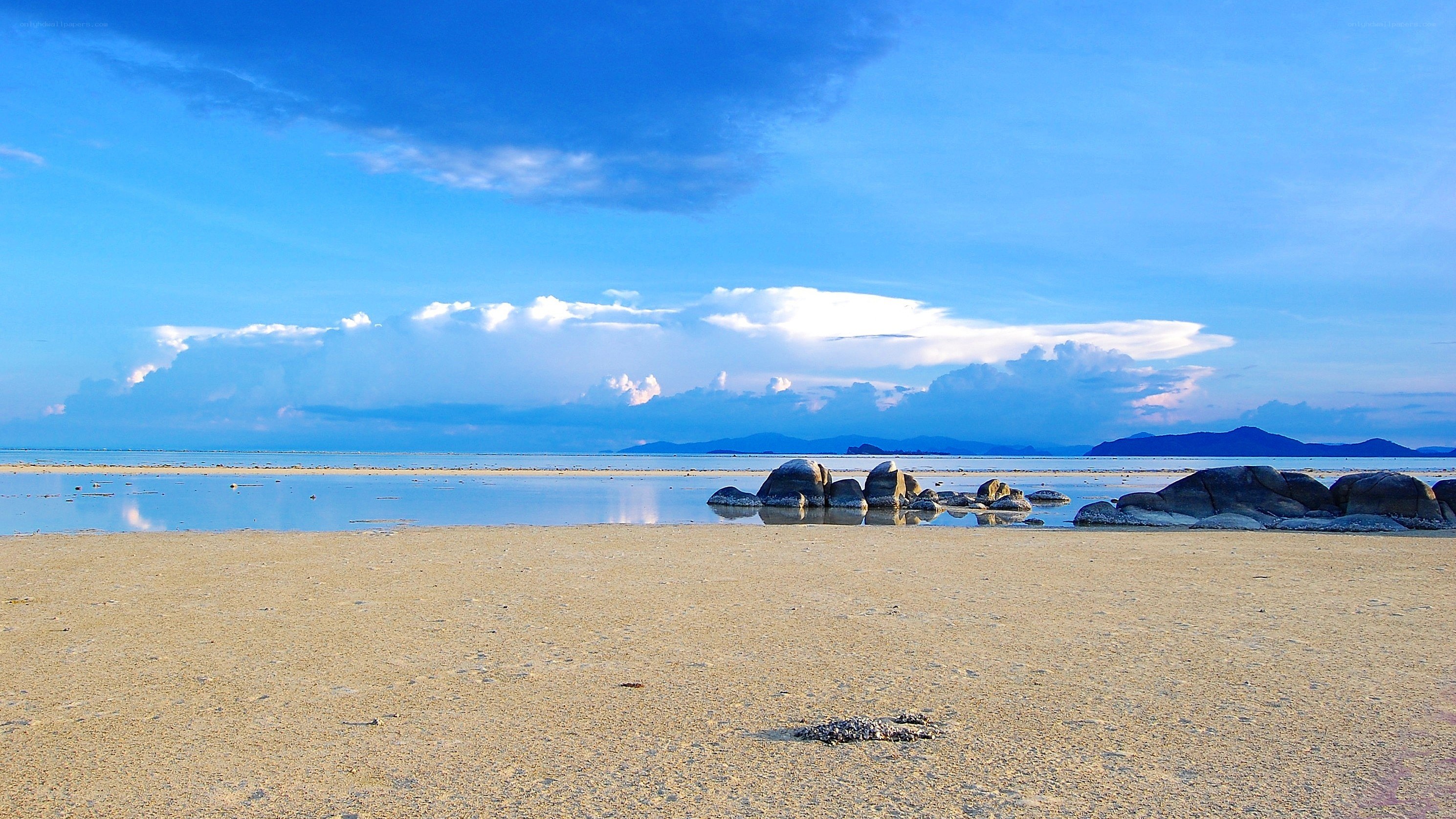 Beach with rocks and blue sky