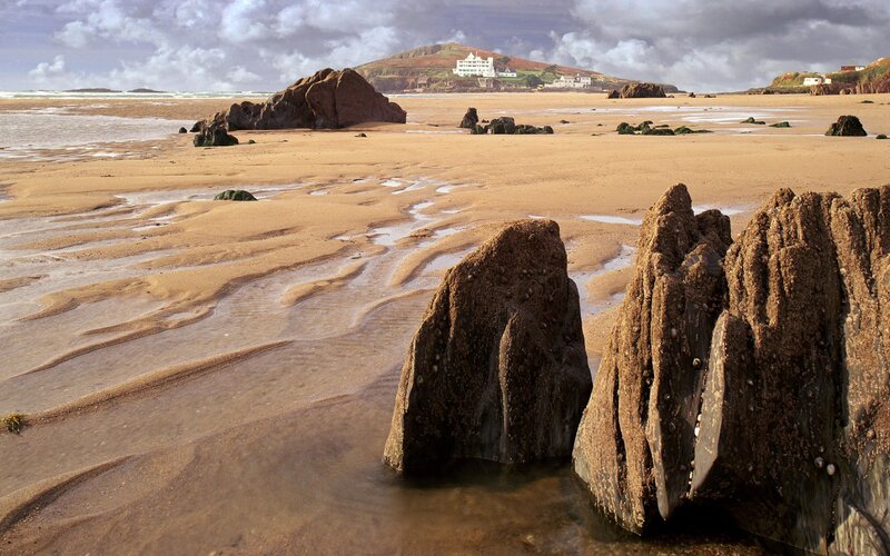 Beach with Rocks and Buildings — Brown, Dramatic
