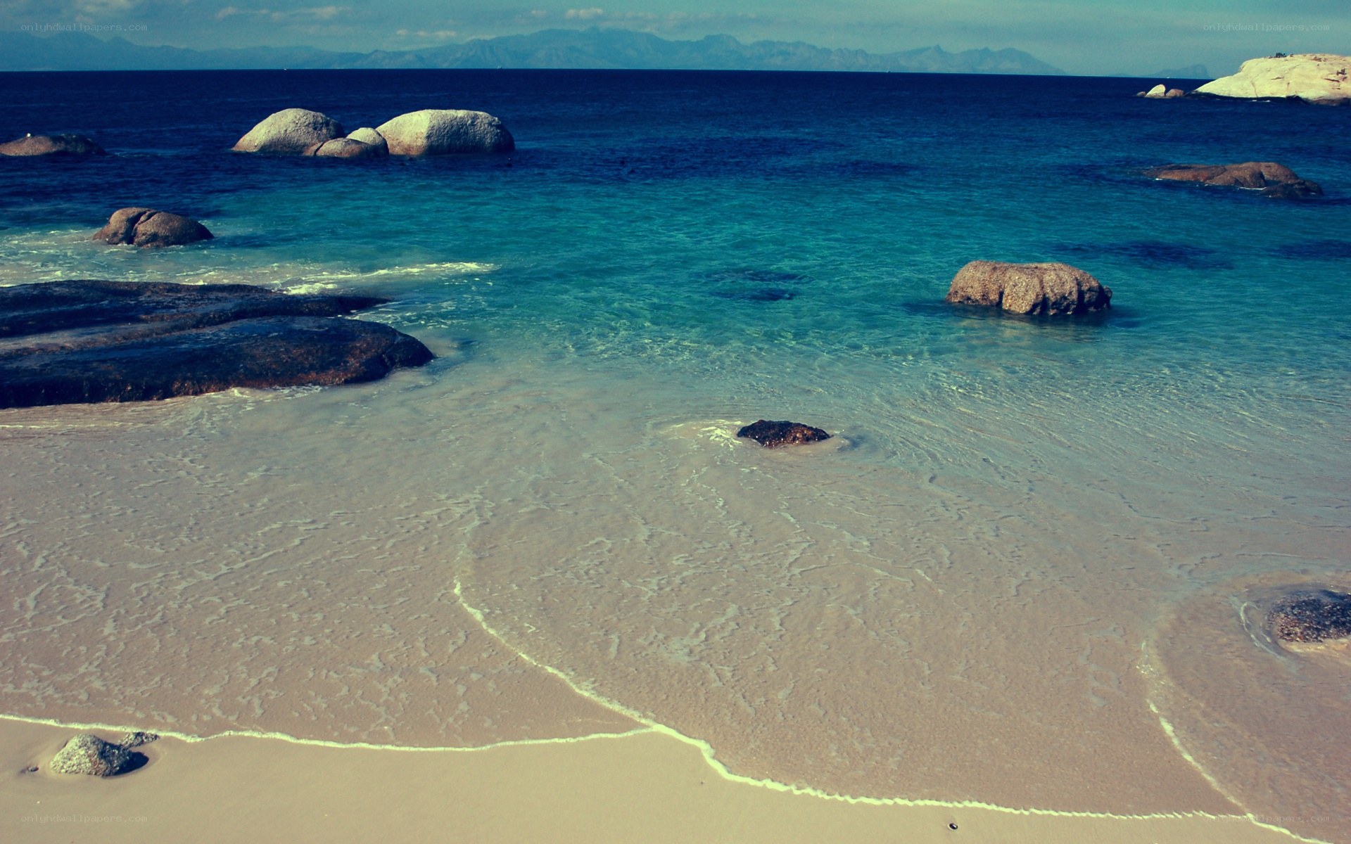 beach with rocks and clear water