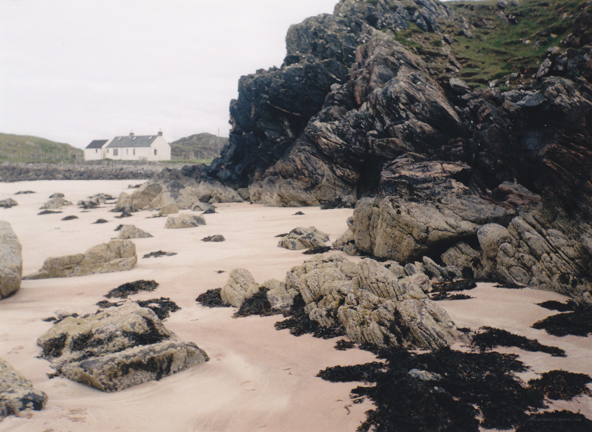 beach with rocks and cottage