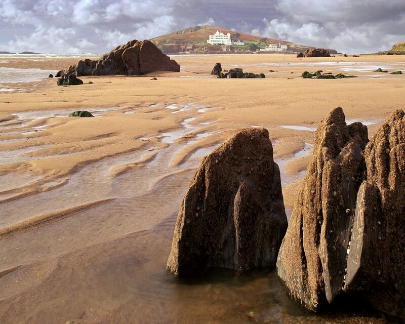 beach with rocks and distant buildings