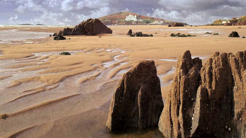 beach with rocks and distant buildings