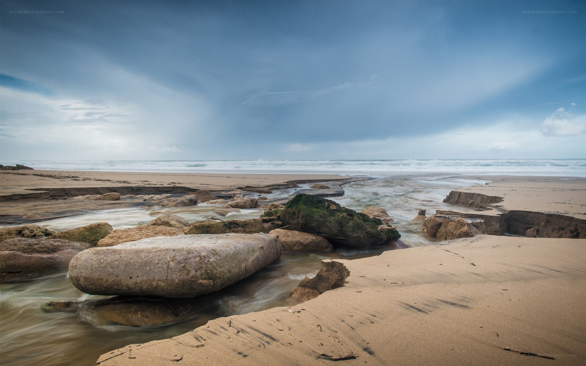Beach with rocks and flowing water