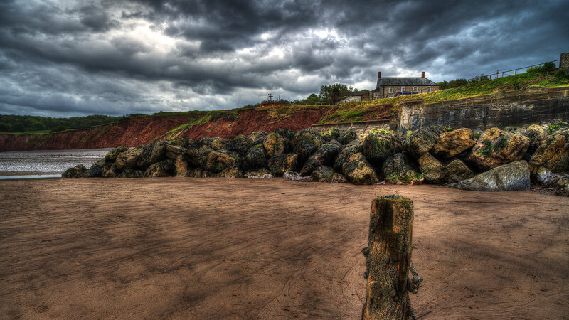 Beach with Rocks and House