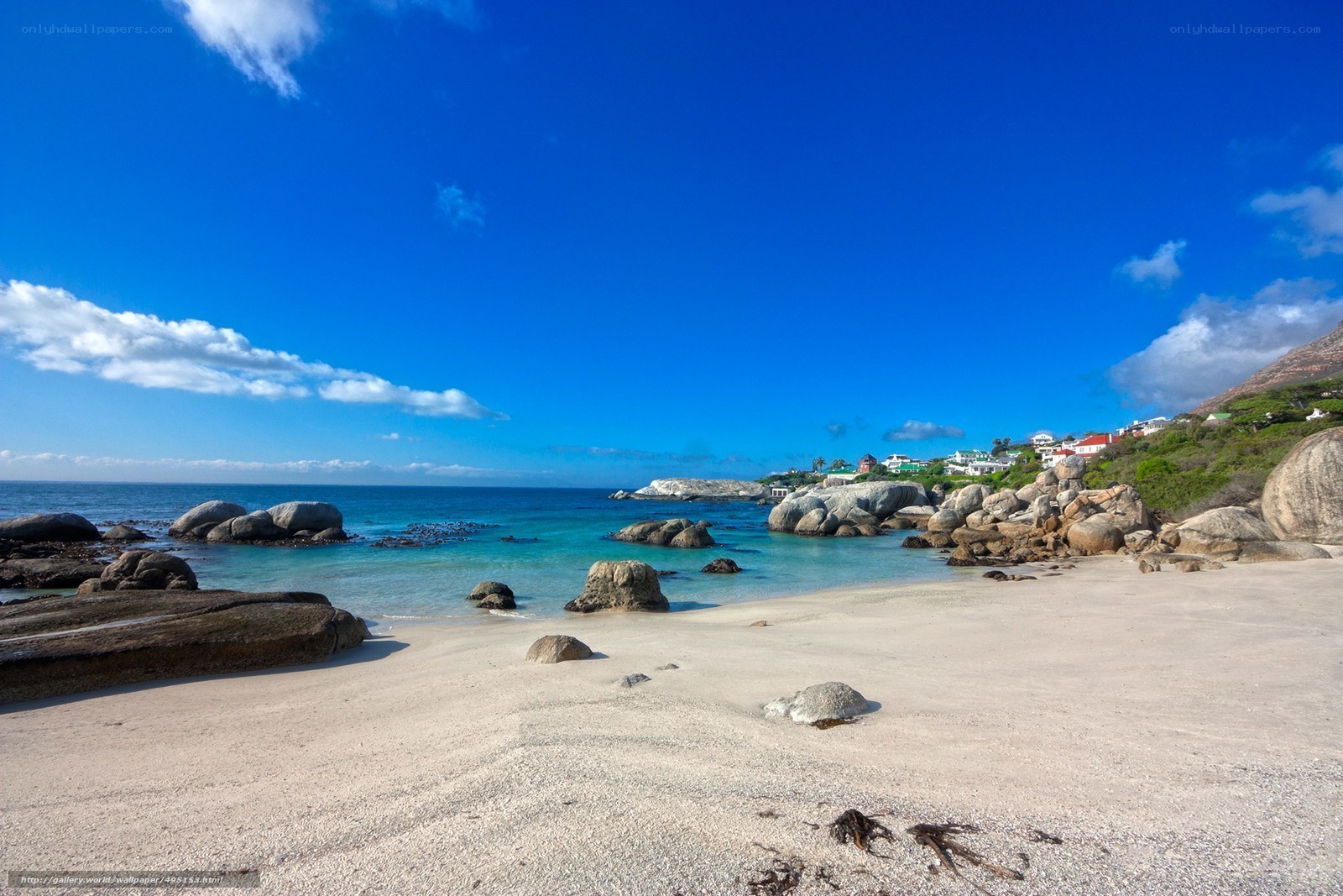 Beach with rocks and houses