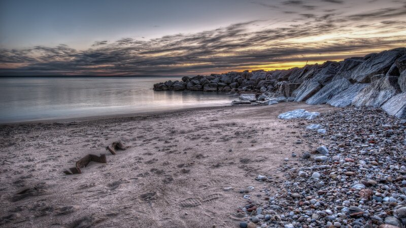 Beach with Rocks and Pier