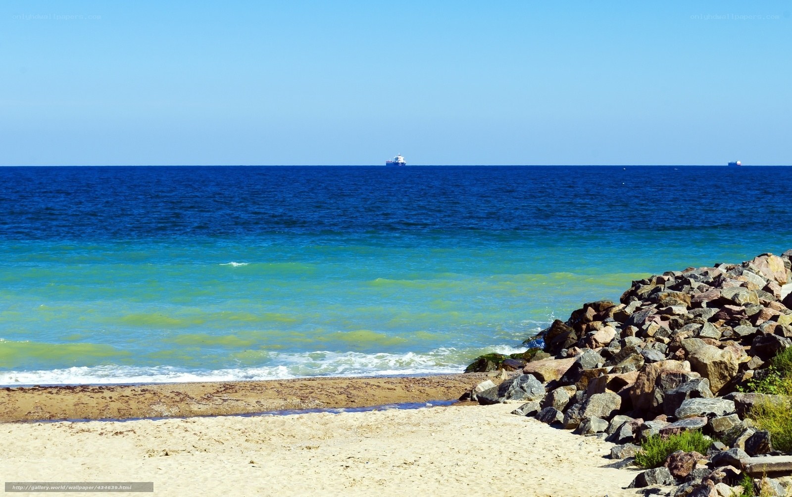 Beach with rocks and ship