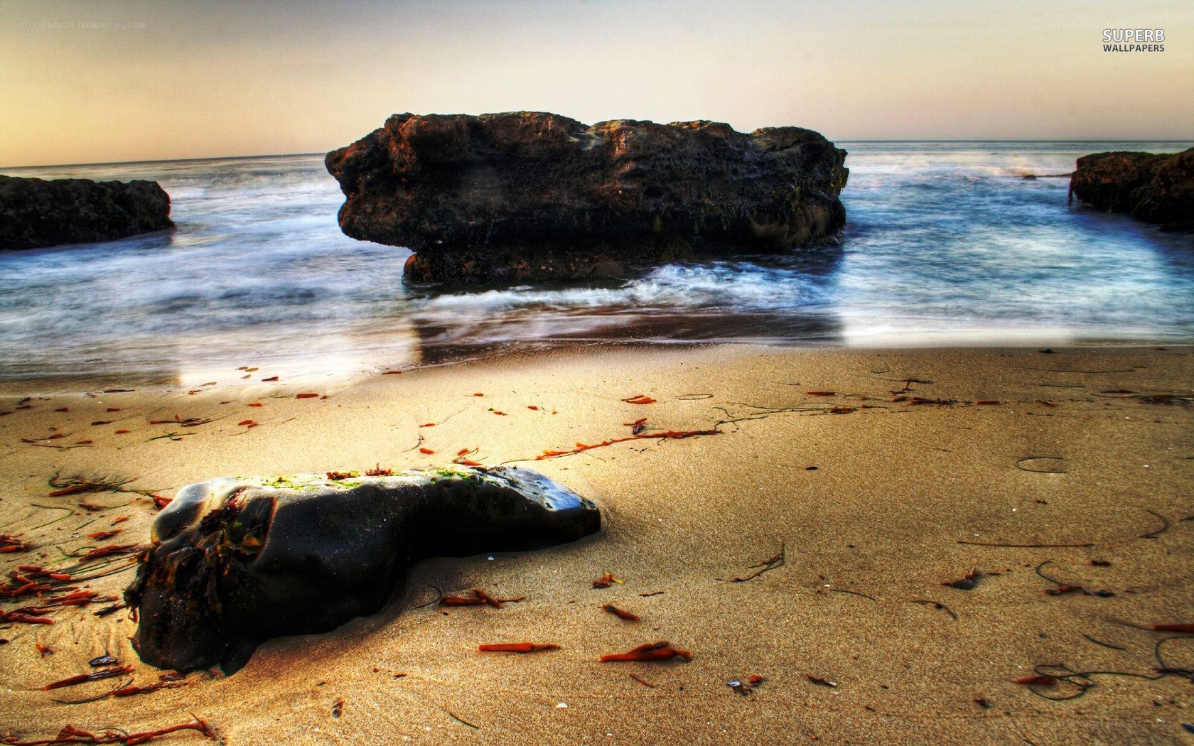beach with rocks at sunset