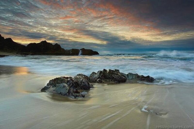 Beach with Rocks at Sunset — Orange, Dramatic, Photograph