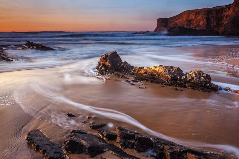 Beach with Rocks at Sunset — Orange, Serene, Photograph, Ocean, Cliffs, Sand