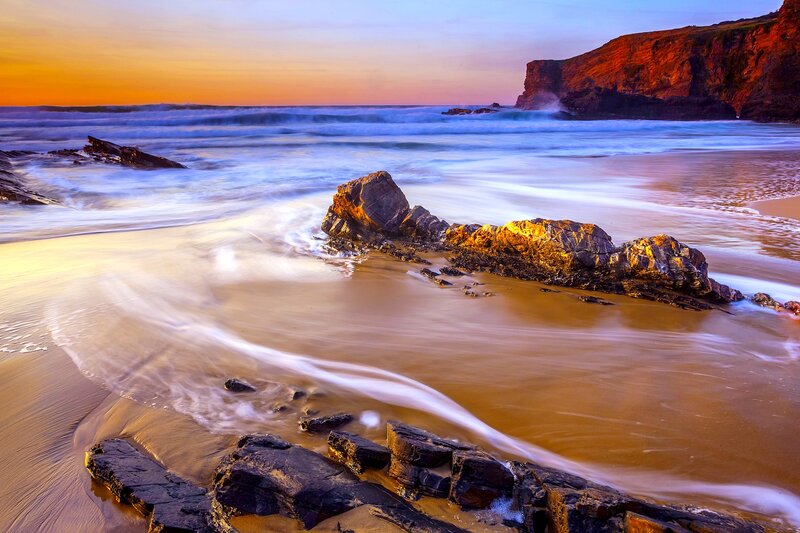 Beach with Rocks at Sunset — Orange, Serene