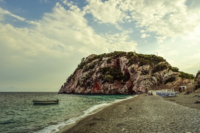 Beach with rocky cliff and boat