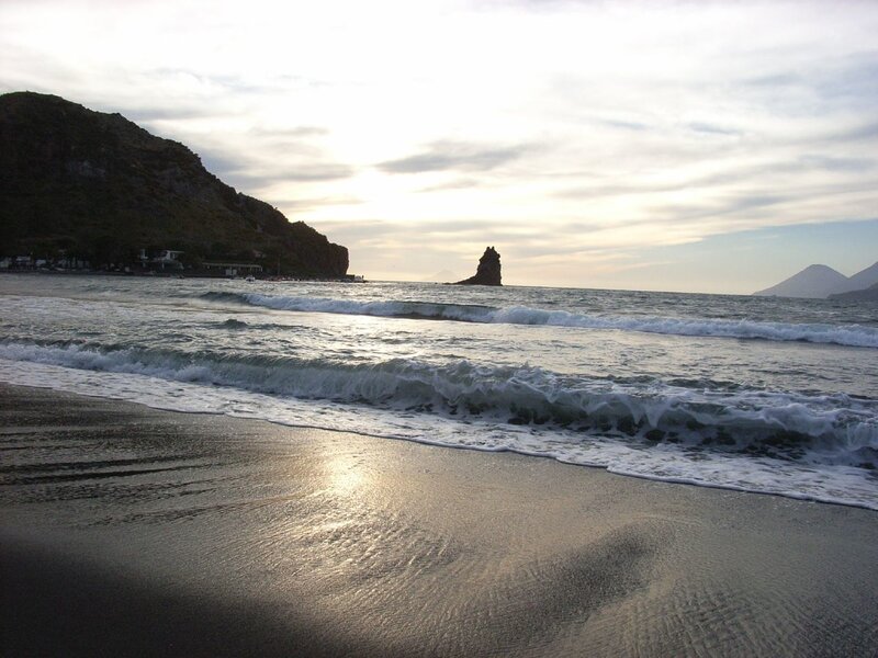 beach with rocky cliffs at sunset